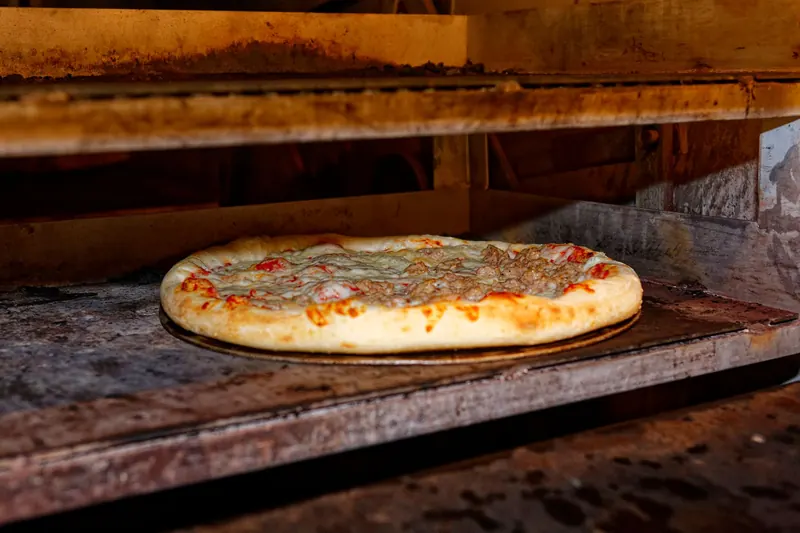 Hot and delicious pizza baking in a traditional stone oven
